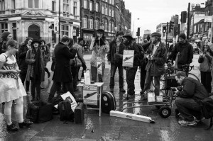 The Citizen's Kazoo Orchestra on the rainy streets of Camden, protesting against a draconian policy that would make playing wind instruments on the streets of Camden illegal
